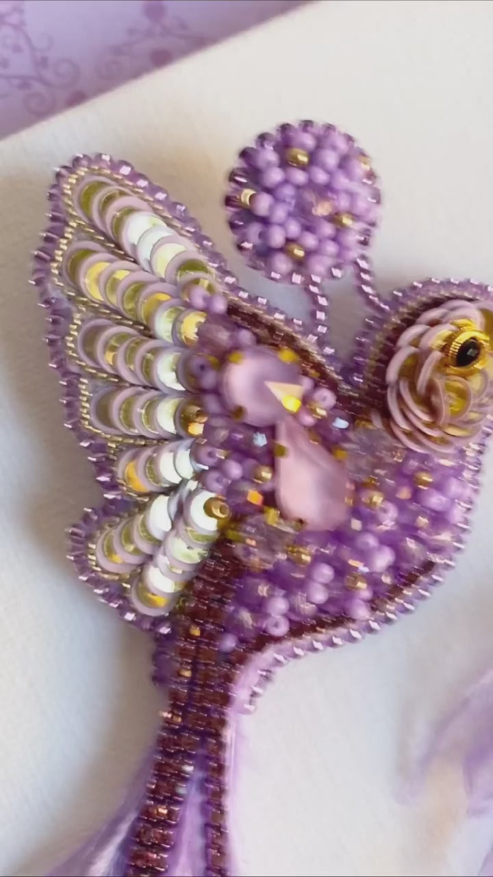 Load video: Crafted to dazzle, stitched to last.  Each pair is delicately hand-embroidered with crystals, sequins and vibrant colour because your earrings should reflect your sparkle.